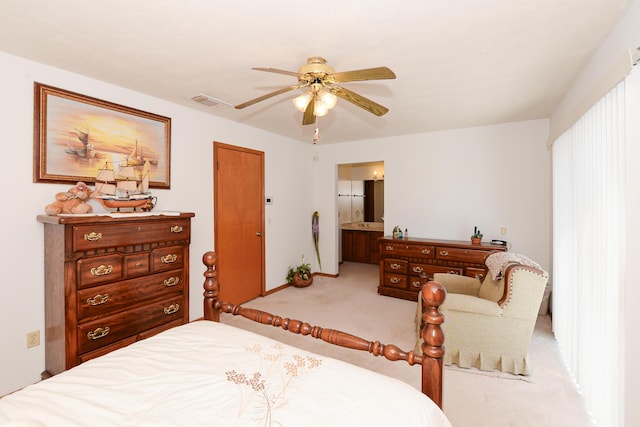 bedroom featuring light colored carpet, connected bathroom, a ceiling fan, and baseboards