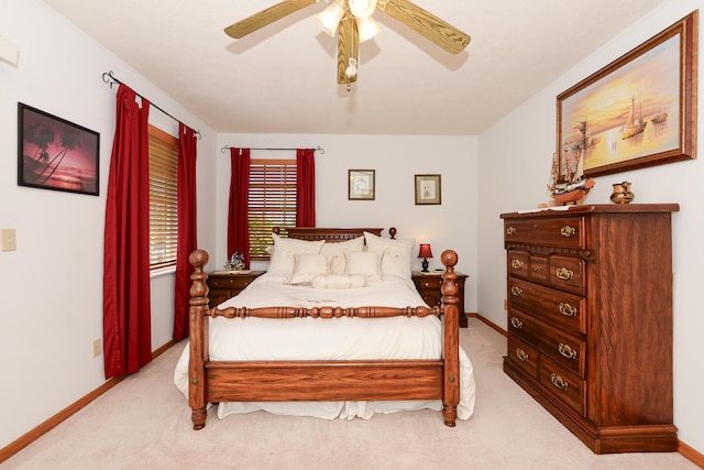 bedroom featuring light carpet, baseboards, and ceiling fan