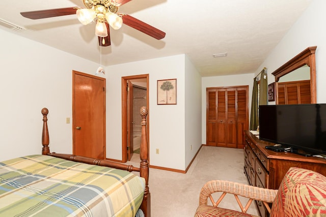bedroom with light colored carpet, ceiling fan, and baseboards