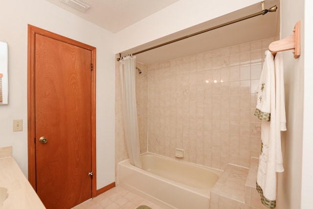 bathroom with shower / bathtub combination with curtain and baseboards