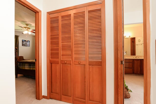 detailed view of carpet floors and a ceiling fan