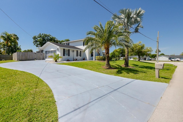 ranch-style home with driveway, an attached garage, and stucco siding