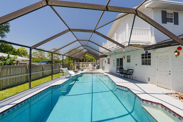 view of pool with a patio area and a lanai