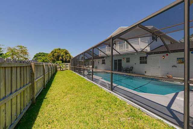 view of swimming pool with glass enclosure and a patio