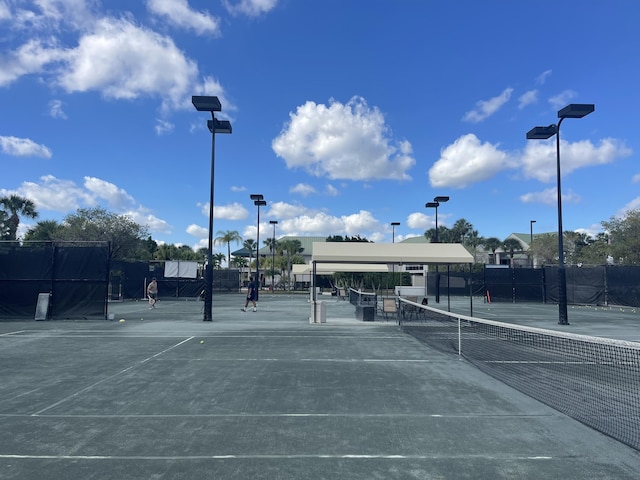 view of tennis court with fence