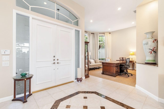 entryway with recessed lighting, tile patterned floors, and baseboards