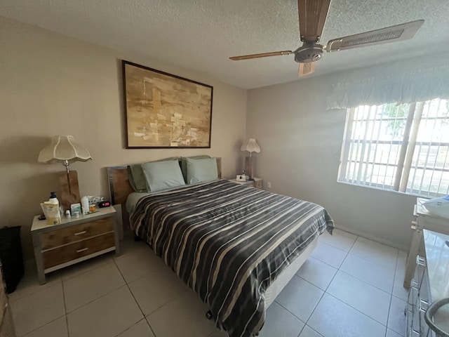 bedroom with ceiling fan, a textured ceiling, and light tile patterned flooring