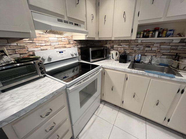 kitchen featuring sink, white electric range oven, light tile patterned floors, and decorative backsplash