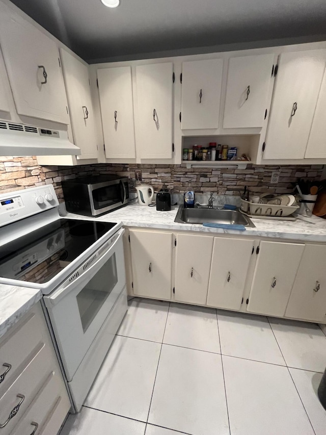 kitchen with sink, white electric range, light tile patterned floors, and decorative backsplash