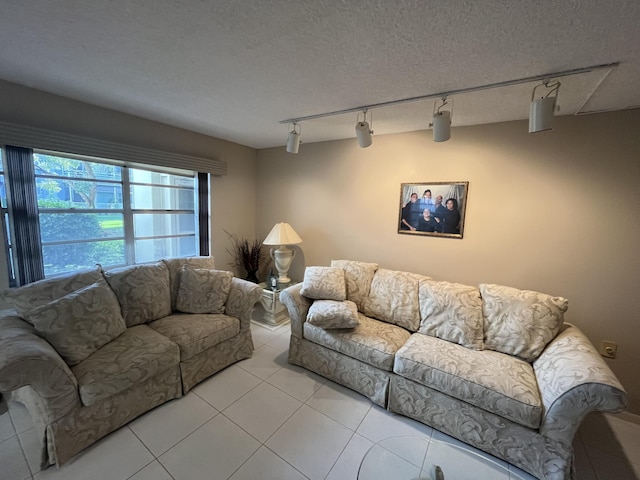 living room featuring light tile patterned floors and a textured ceiling