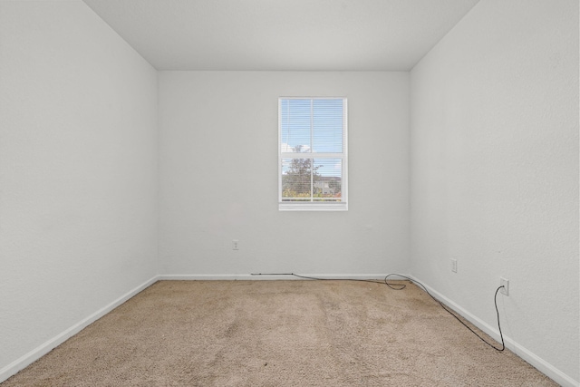 empty room with carpet floors and baseboards