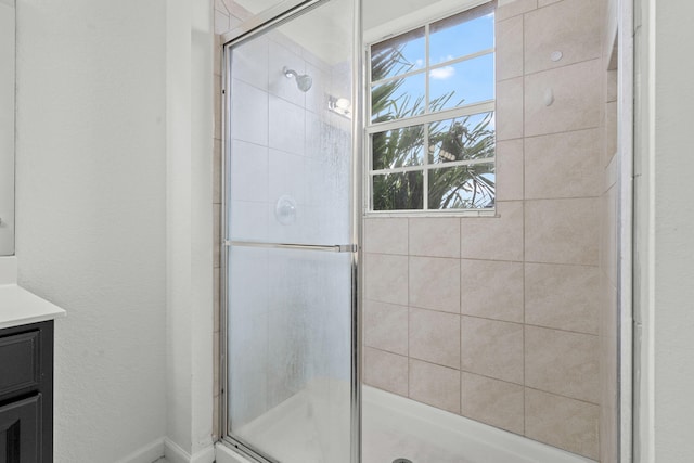 bathroom with a stall shower and vanity