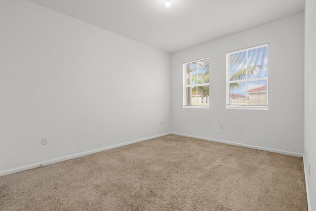 spare room with carpet floors and baseboards