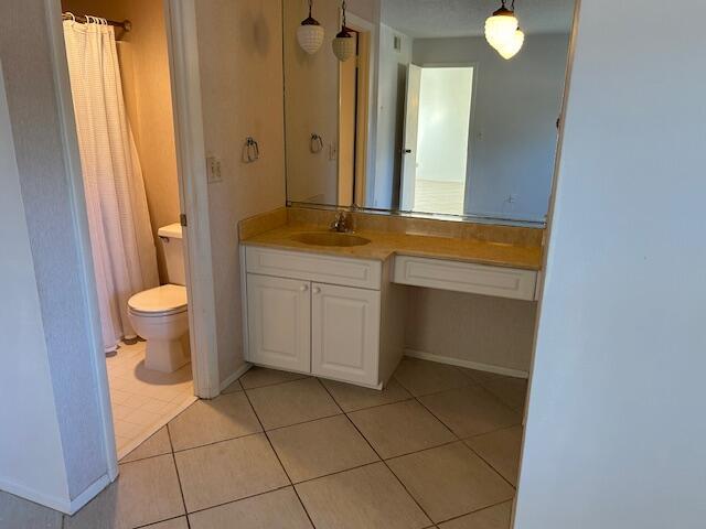 bathroom with vanity, tile patterned floors, and toilet