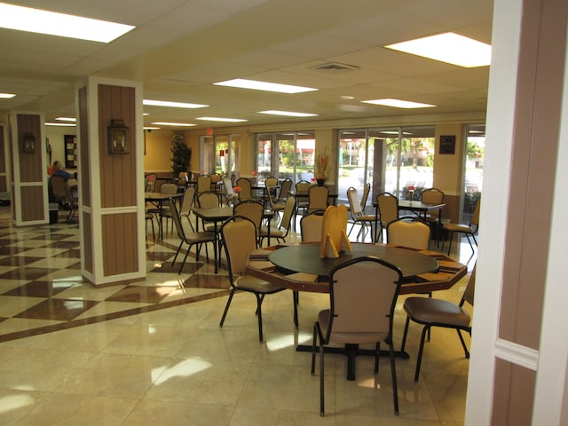 dining room featuring a drop ceiling