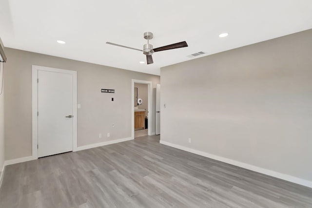 spare room featuring ceiling fan and light wood-type flooring