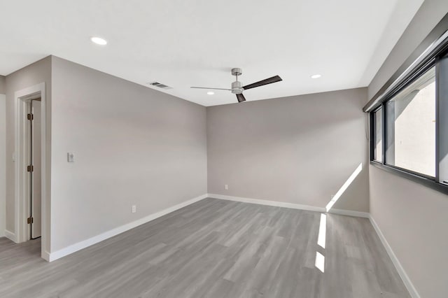 unfurnished room with ceiling fan and light hardwood / wood-style floors