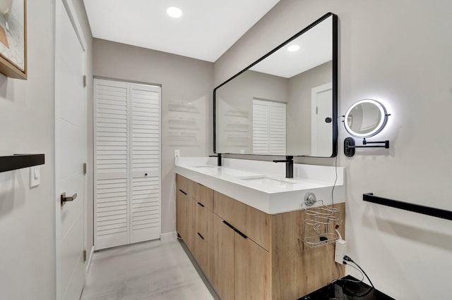 bathroom with concrete flooring and vanity