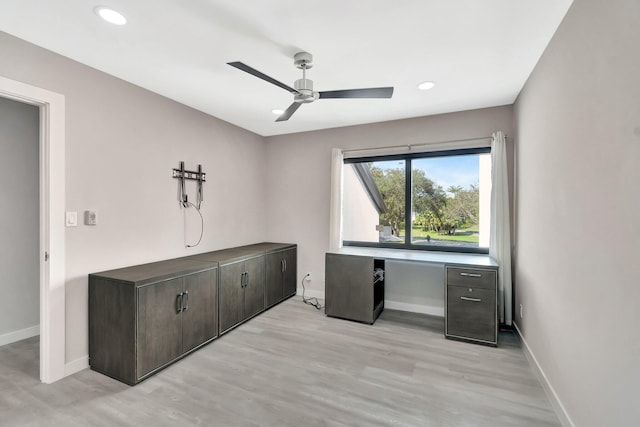 home office with ceiling fan and light hardwood / wood-style floors