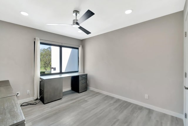 unfurnished office featuring ceiling fan and light wood-type flooring