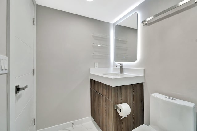 bathroom with vanity and toilet