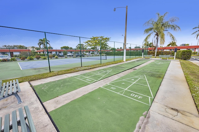 view of community featuring tennis court