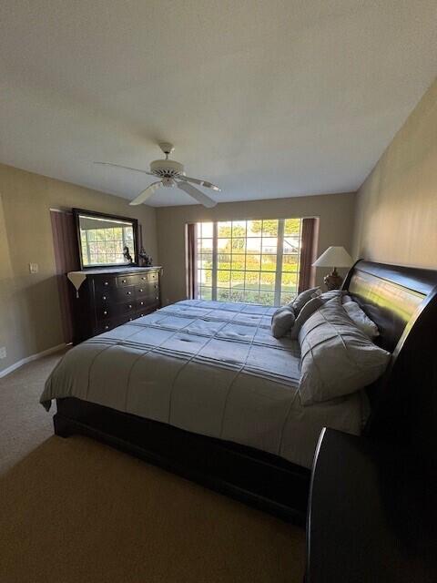 bedroom with multiple windows, carpet flooring, and ceiling fan