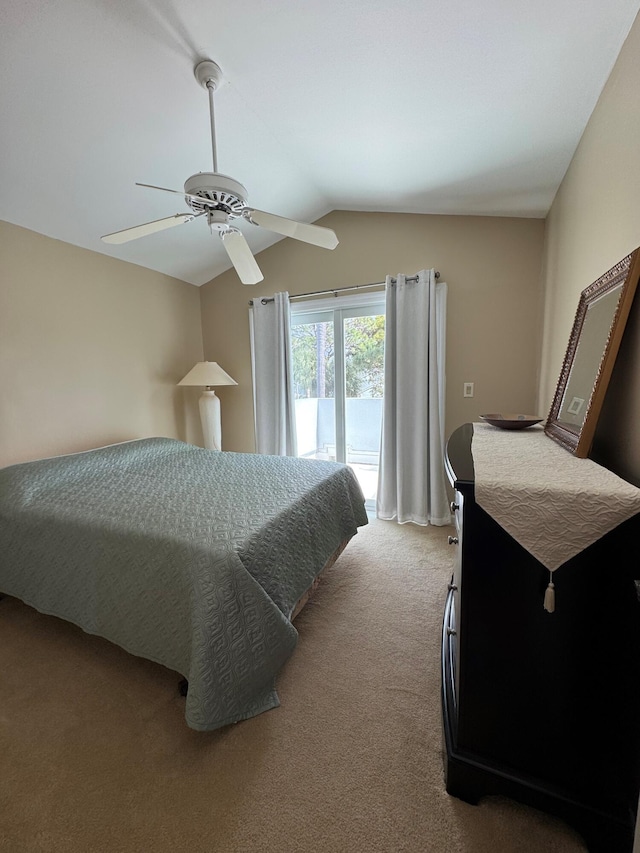 carpeted bedroom featuring ceiling fan, vaulted ceiling, and access to outside