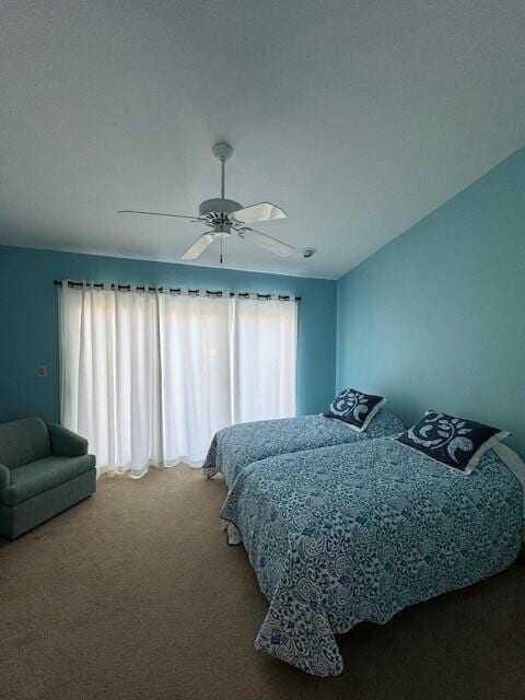 bedroom featuring ceiling fan and carpet