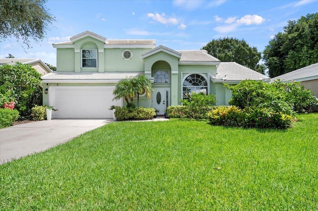 mediterranean / spanish-style house with a garage and a front yard