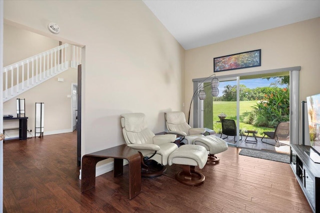 sitting room with dark hardwood / wood-style floors and high vaulted ceiling