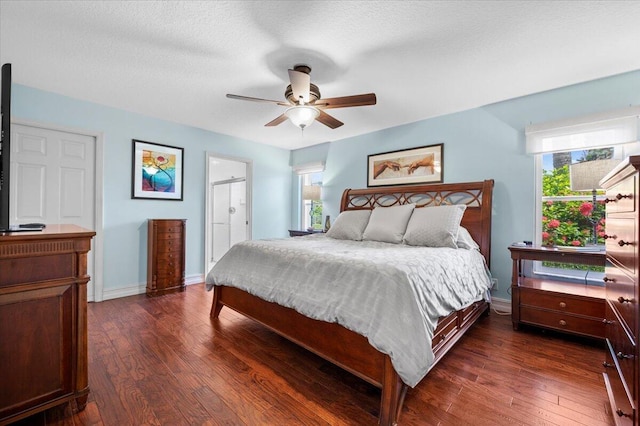 bedroom with dark hardwood / wood-style floors, a textured ceiling, and ceiling fan