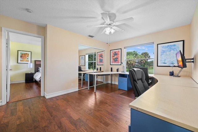 home office featuring a textured ceiling, dark hardwood / wood-style floors, and ceiling fan