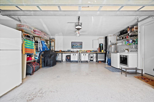 garage with water heater, a workshop area, washer and dryer, and white fridge