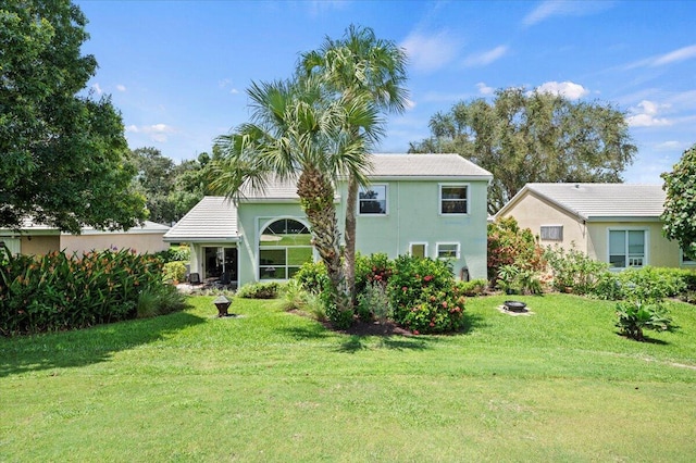 back of house featuring a yard