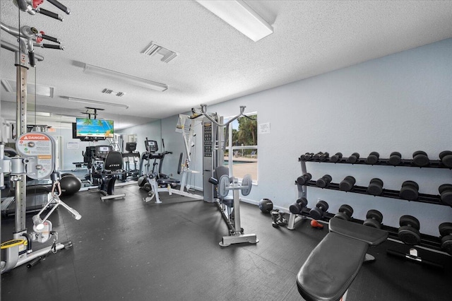 gym featuring a textured ceiling