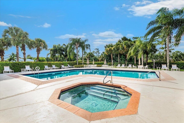 view of pool featuring a community hot tub and a patio area