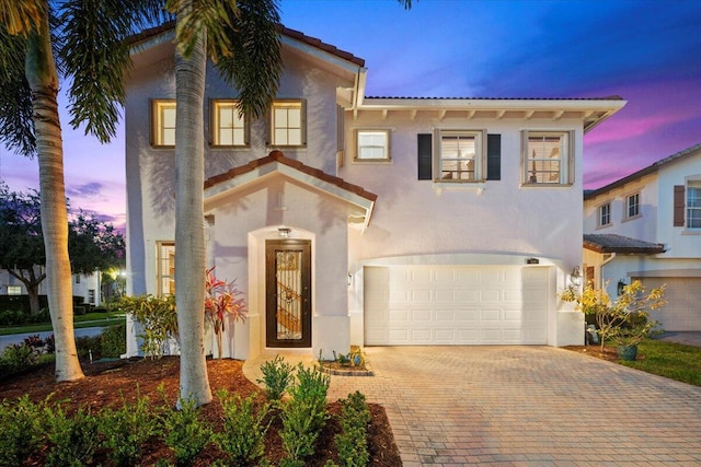 mediterranean / spanish house featuring a garage