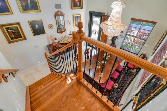 stairway with a chandelier