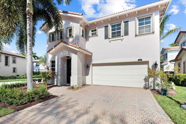 mediterranean / spanish-style home featuring a garage