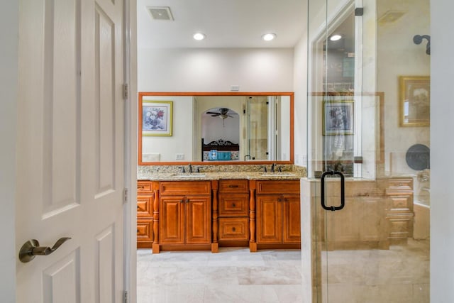 bathroom with walk in shower and vanity