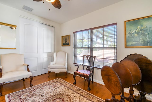 living area featuring ceiling fan and wood-type flooring