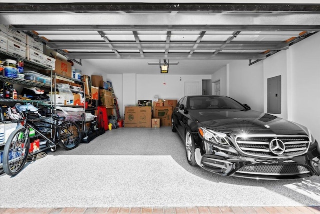 garage featuring a garage door opener and electric panel