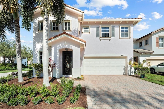 mediterranean / spanish-style home with a garage