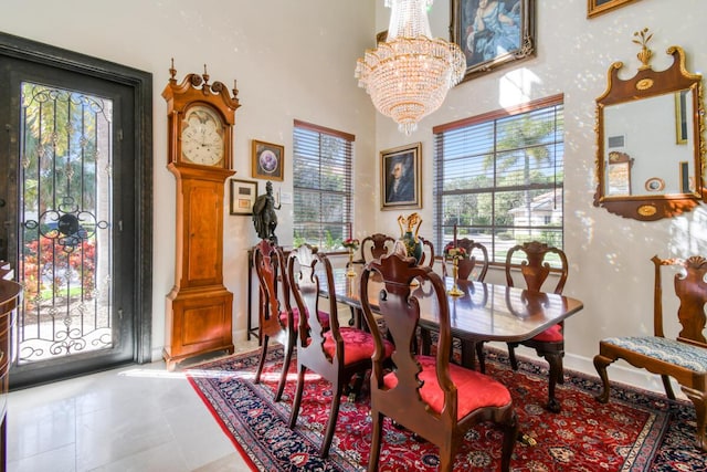 tiled dining room featuring plenty of natural light and a chandelier