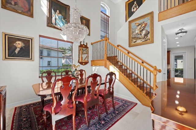 dining area with a notable chandelier and a towering ceiling