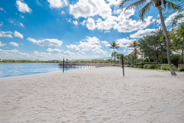 view of property's community with volleyball court and a water view