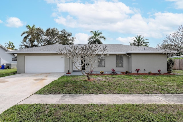 single story home with a garage and a front lawn