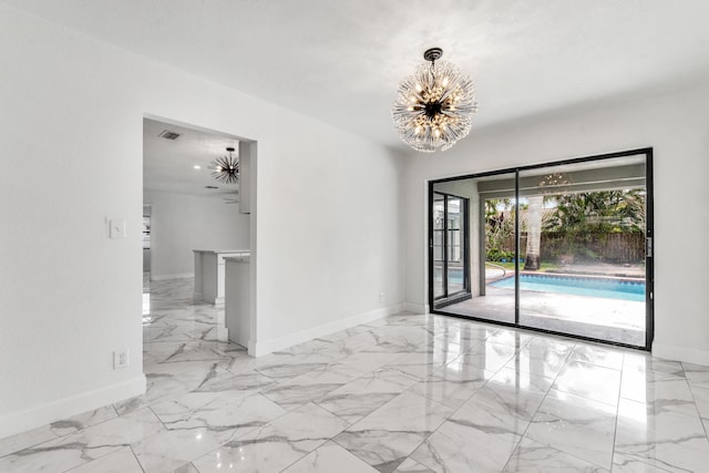 unfurnished room featuring a chandelier