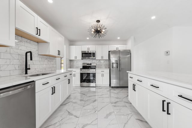 kitchen featuring white cabinetry, appliances with stainless steel finishes, and sink